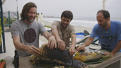 A group of men holding a large fish

AI-generated content may be incorrect.